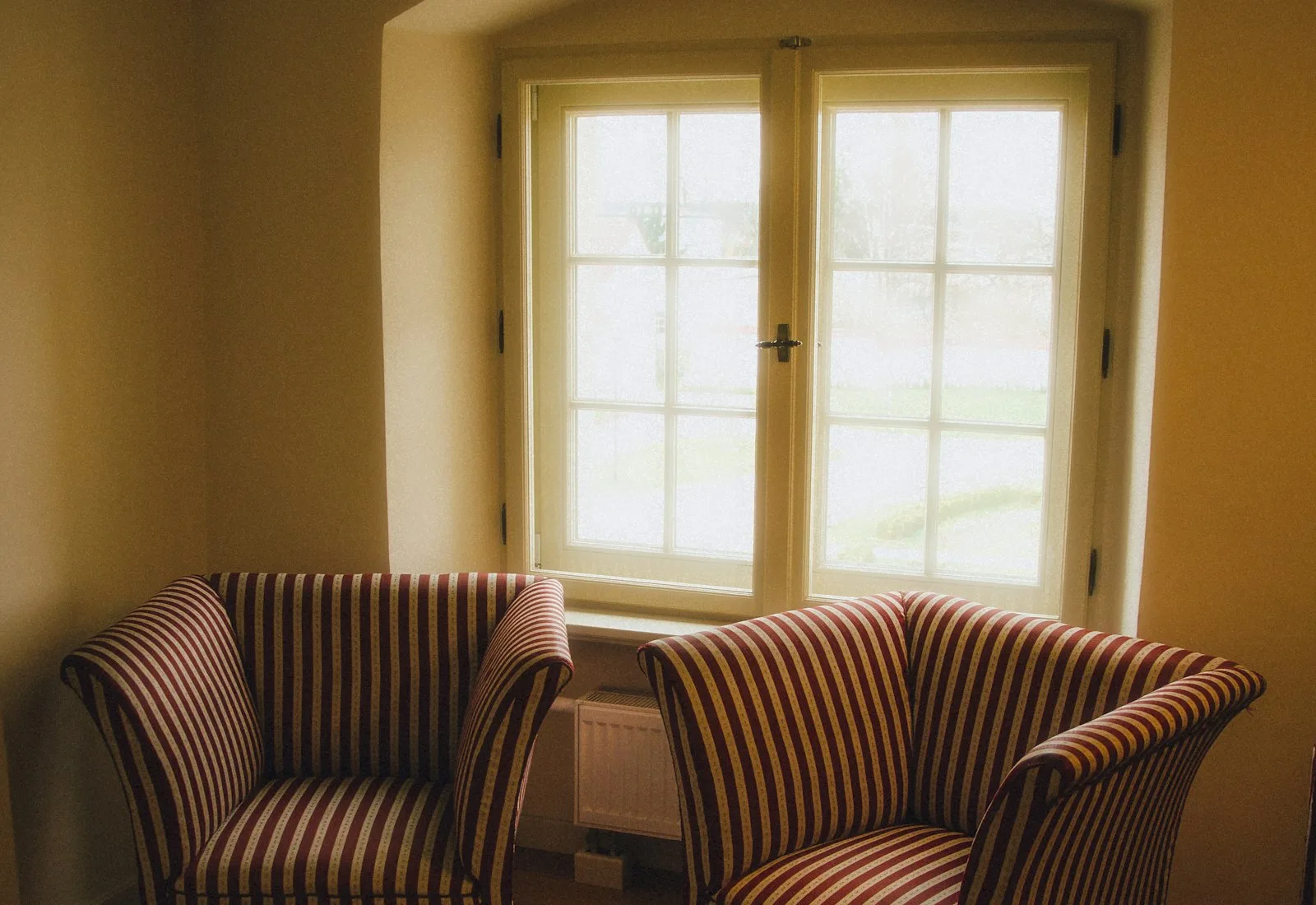 Two chairs by a window in a quiet room