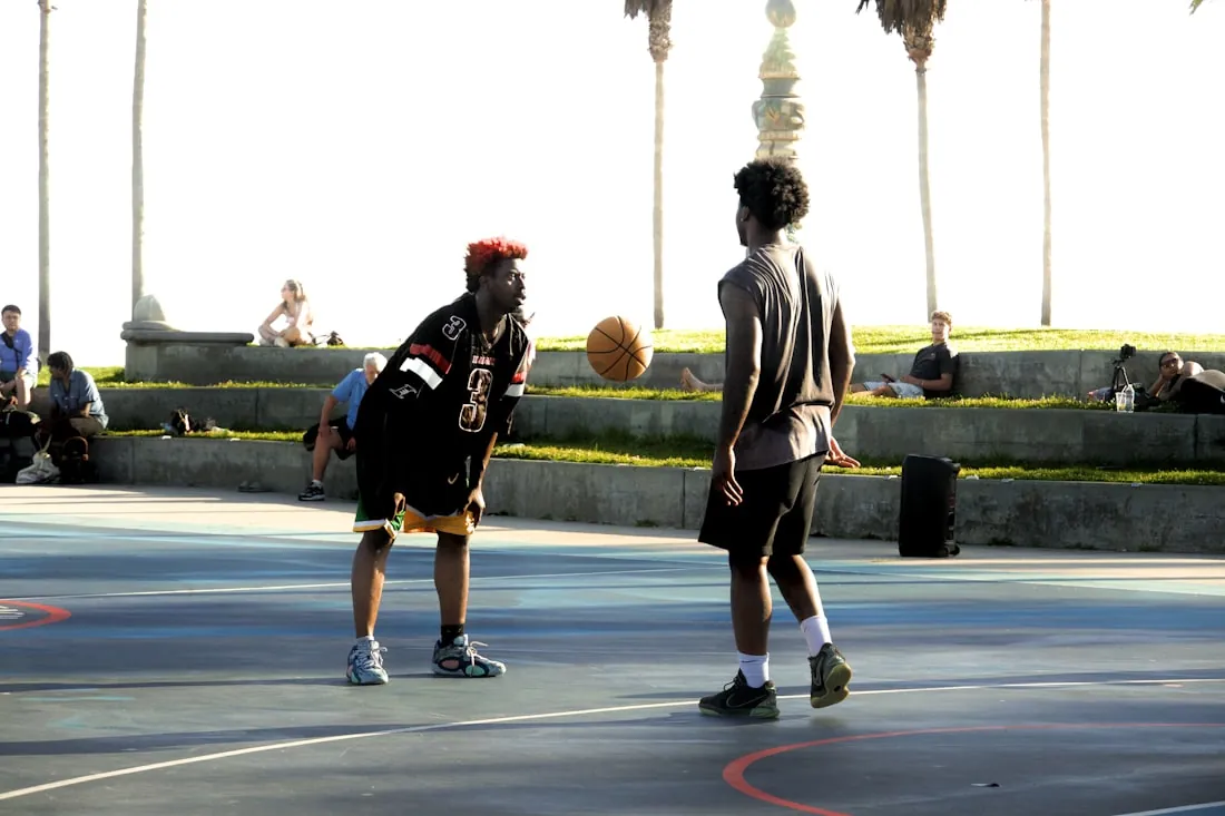 Basketball players mid-game at a community tournament