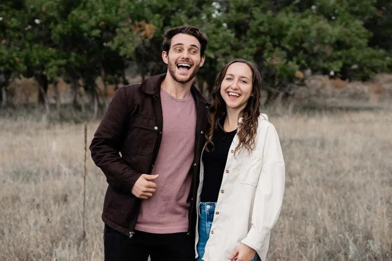 A couple standing together in an open field